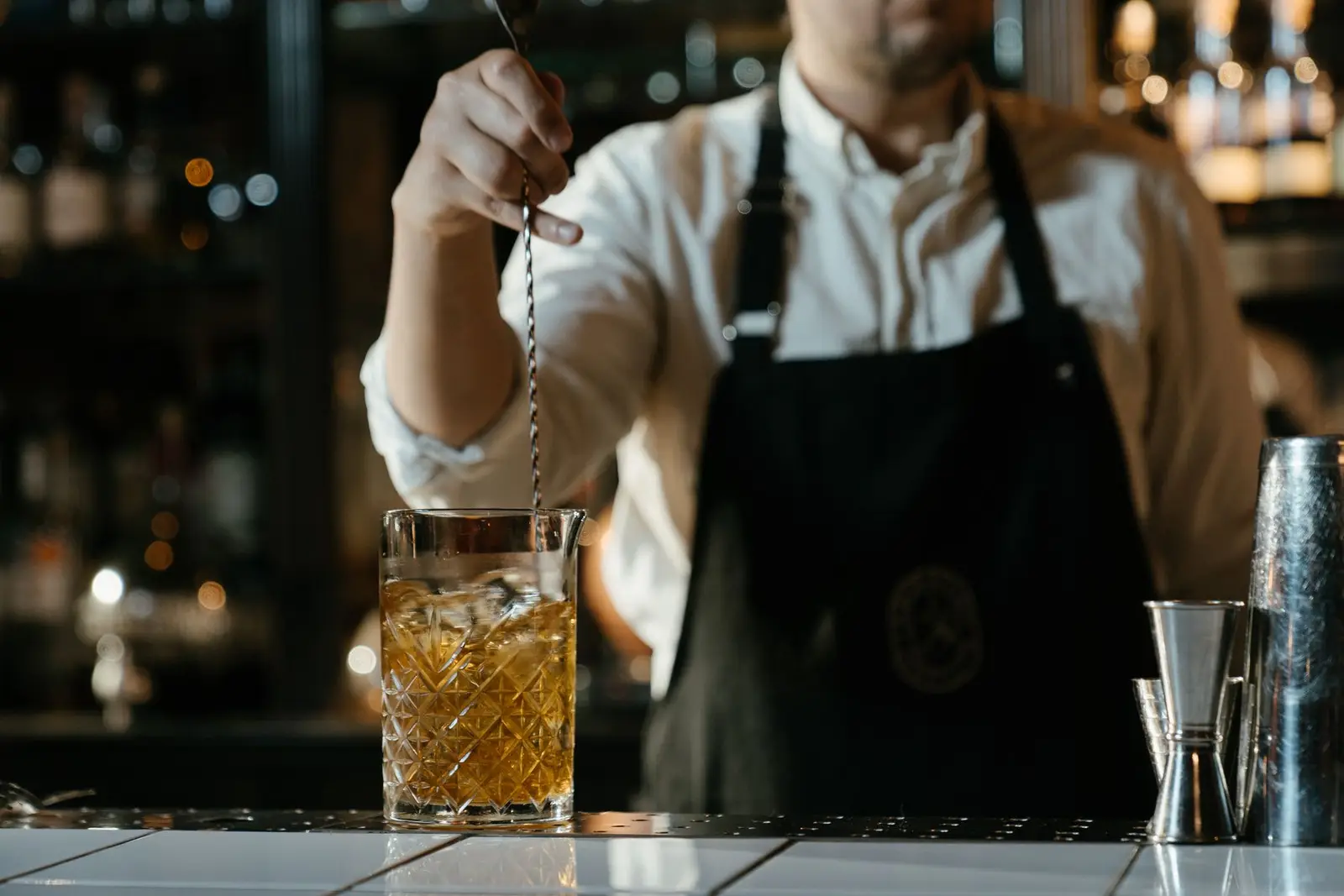 Bartender in an apron behind the bar