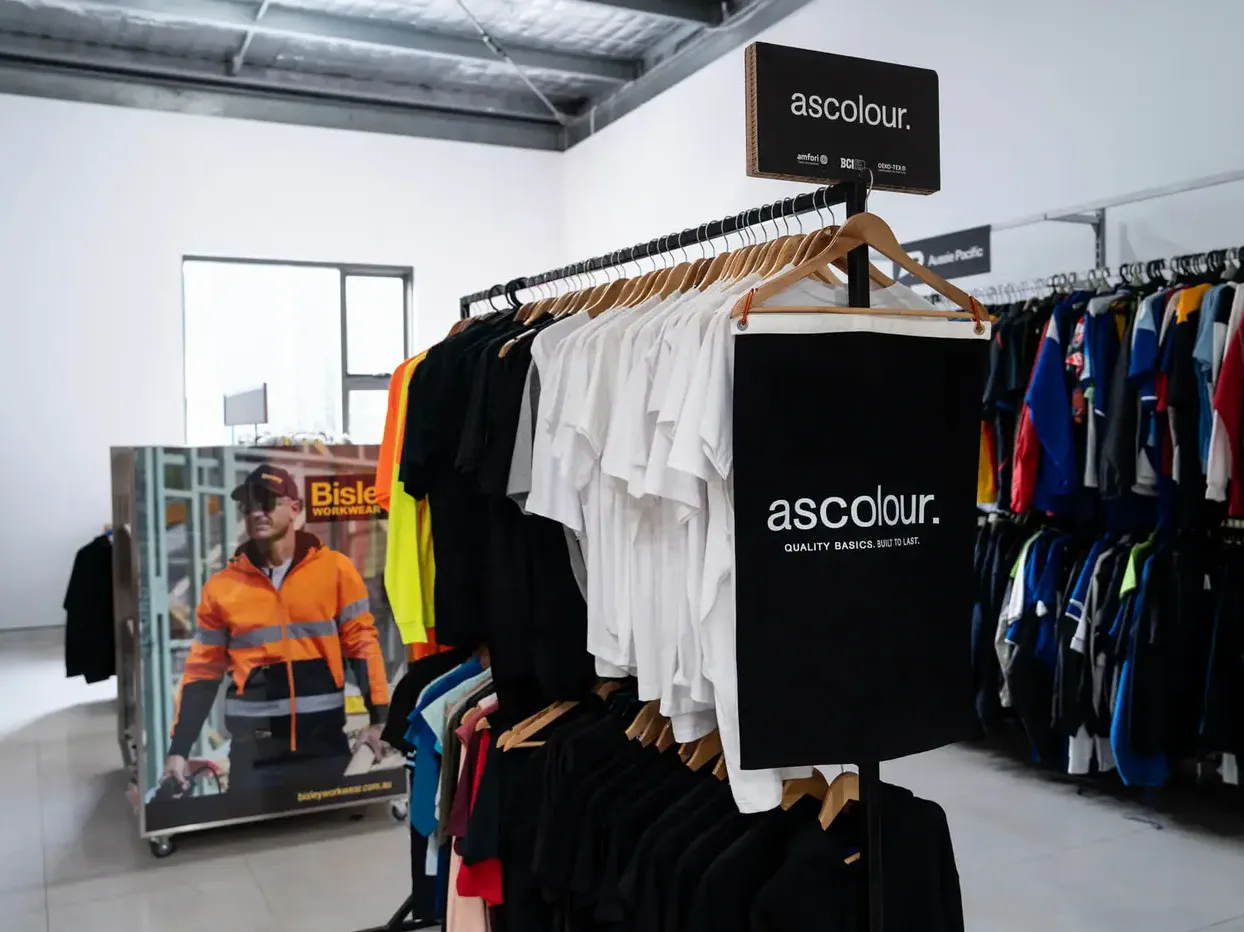 Uniform tees on a display rack inside the HTG Group showroom