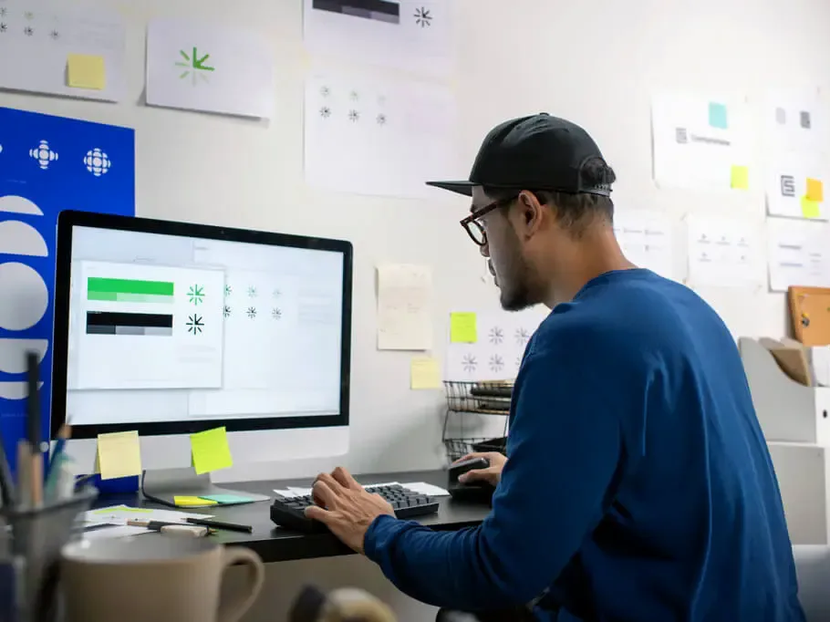 HTG Group designer preparing artwork at a computer