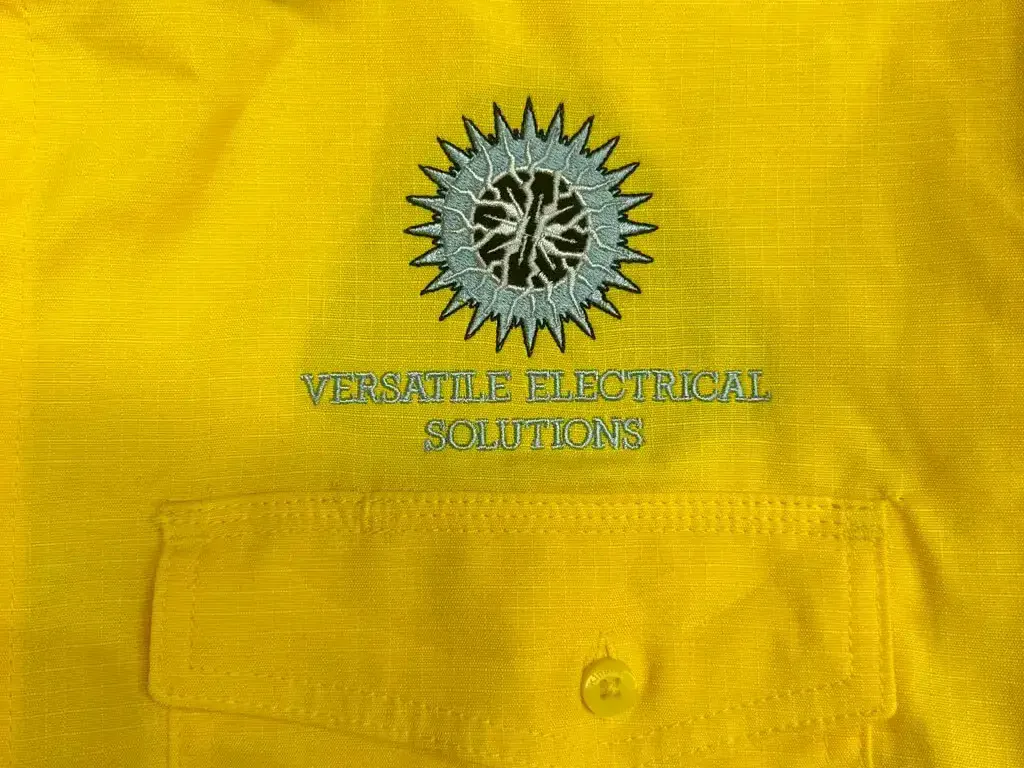 Fluoro yellow work shirt with an embroidered company logo on the chest