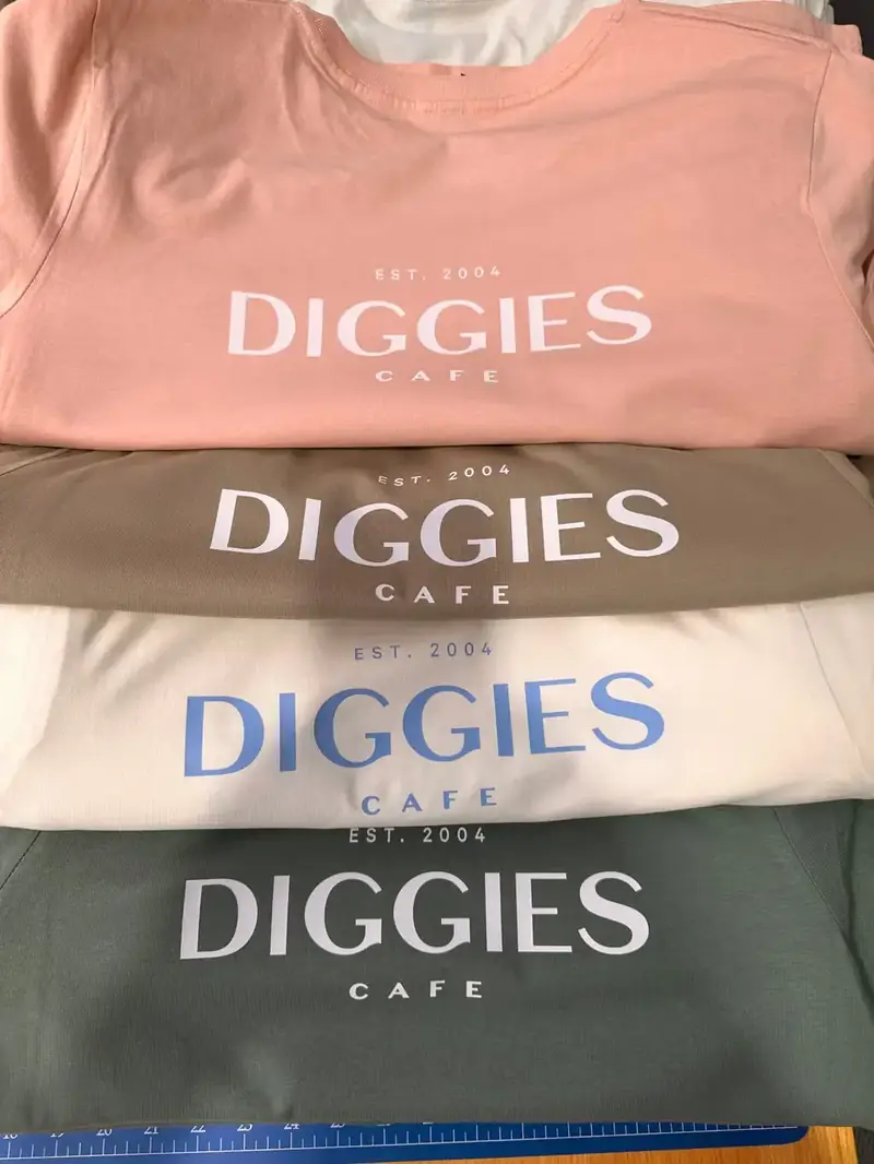 Stack of cafe tees printed in four colours