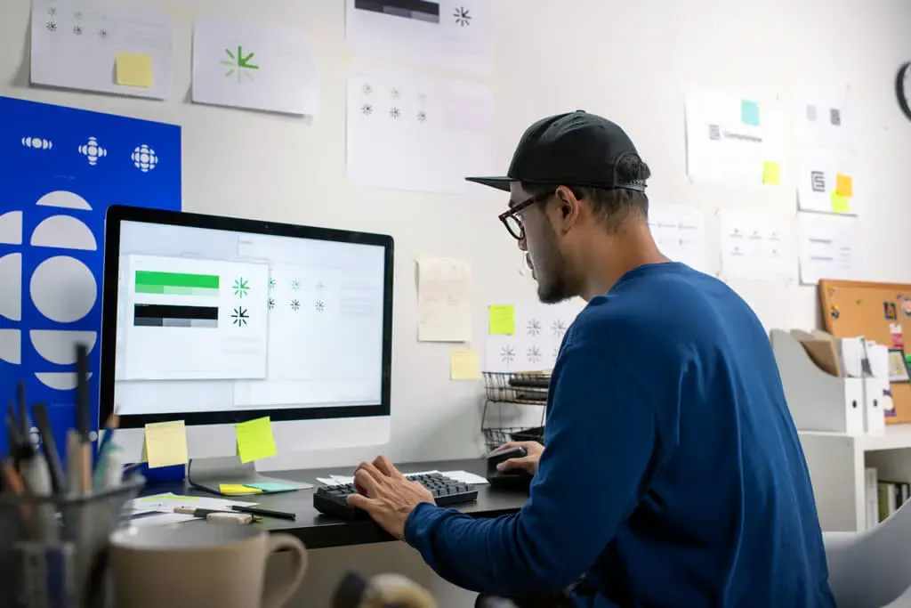 Designer preparing a customer logo for production at the HTG Group design desk