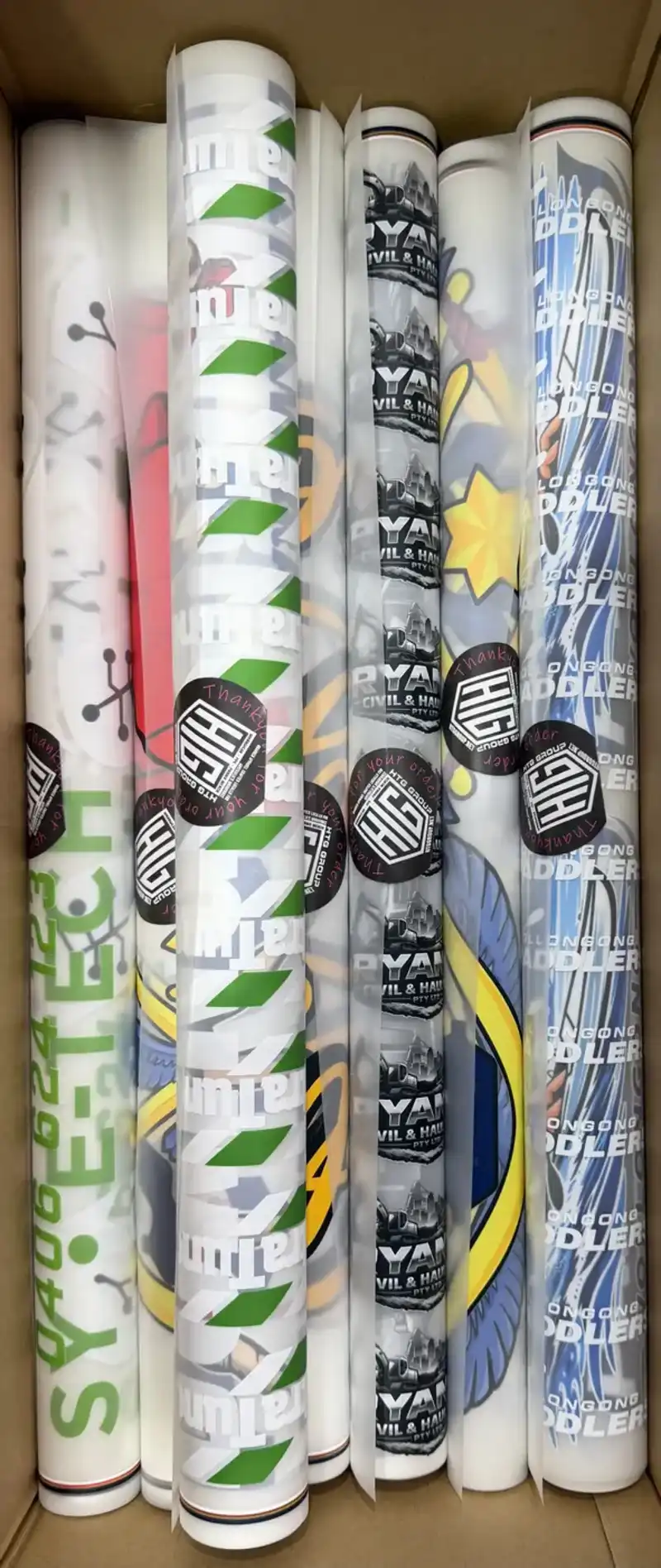 Rolls of printed DTF transfer film stored in a box