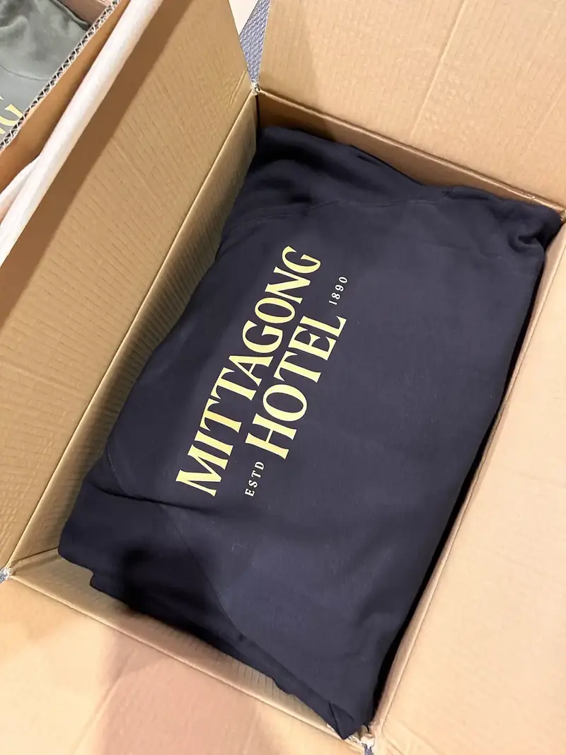 Navy hoodie packed in a box