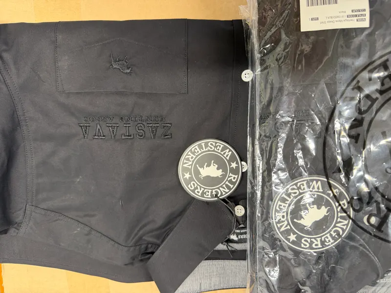 Black garments in the workshop carrying round Ringers Western crest labels and prints