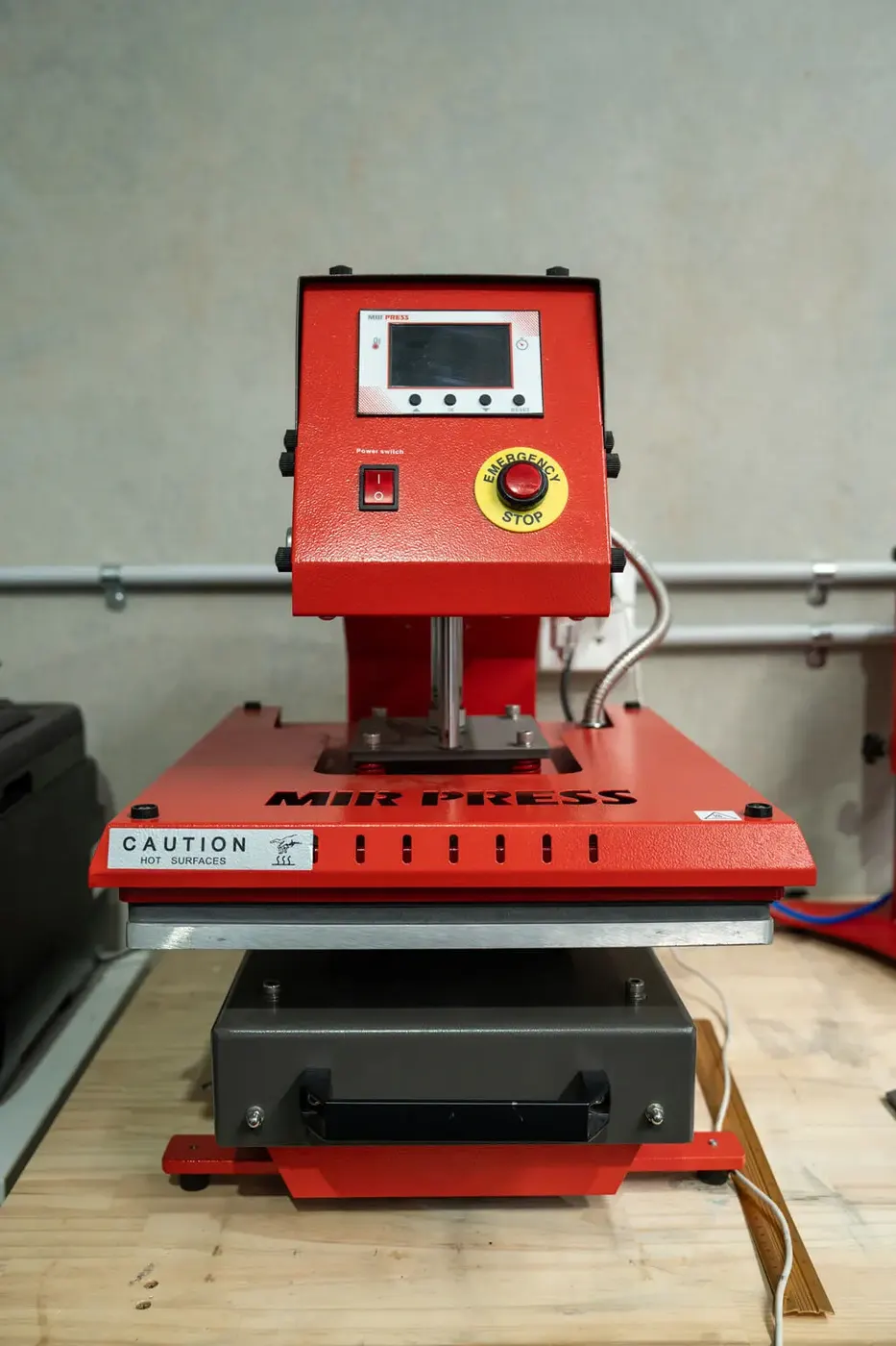 Heat press used to apply DTF transfers in the HTG Group workshop