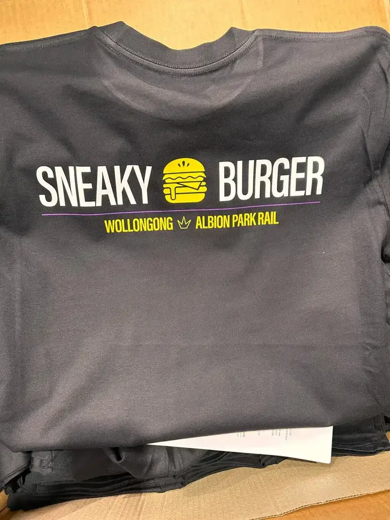 Charcoal tee printed with a burger shop logo