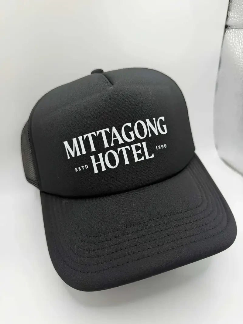 Black trucker cap with a gold embroidered logo